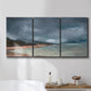 Three-panel canvas wall art featuring stormy sea glass toned coastline, displayed in a bathroom above a bathtub.