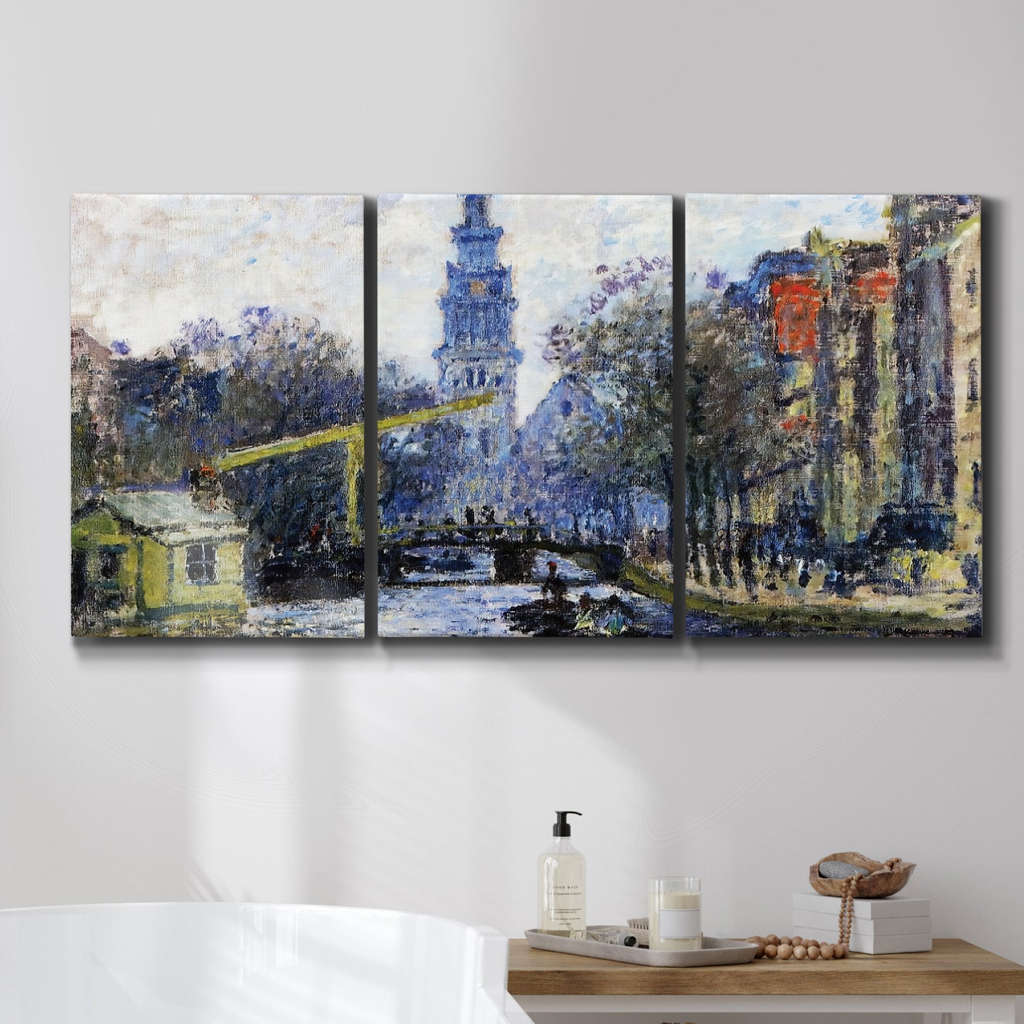 Three-panel canvas wall art featuring historic tower beside canal, displayed in a bathroom above a bathtub.