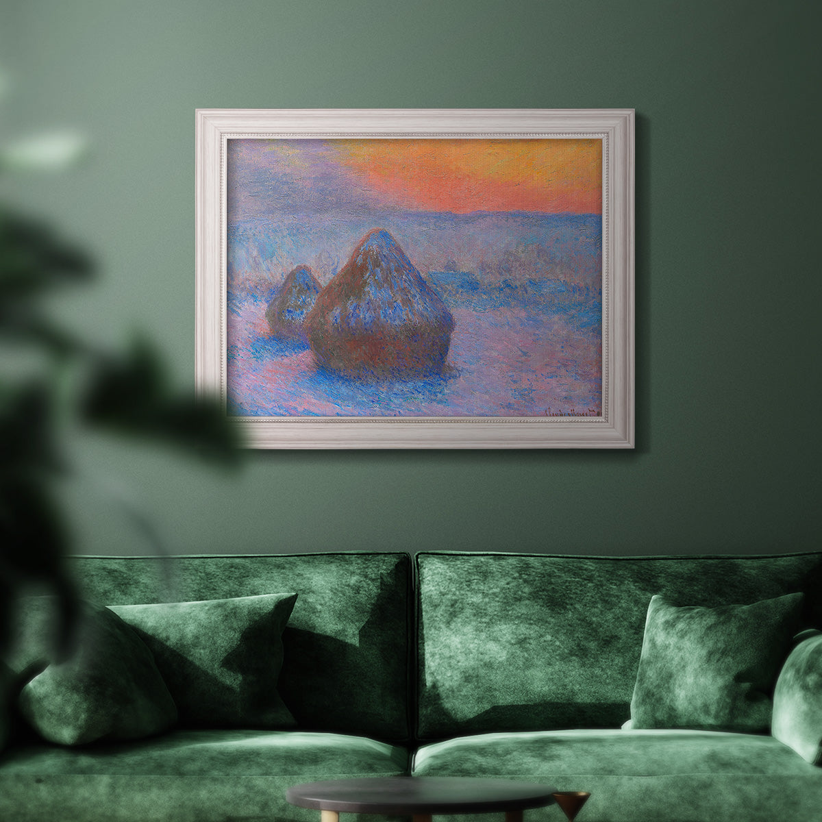 Impressionist haystack scene at sunset by Claude Monet in an ornate weathered white frame displayed in a dark-toned interior setting.