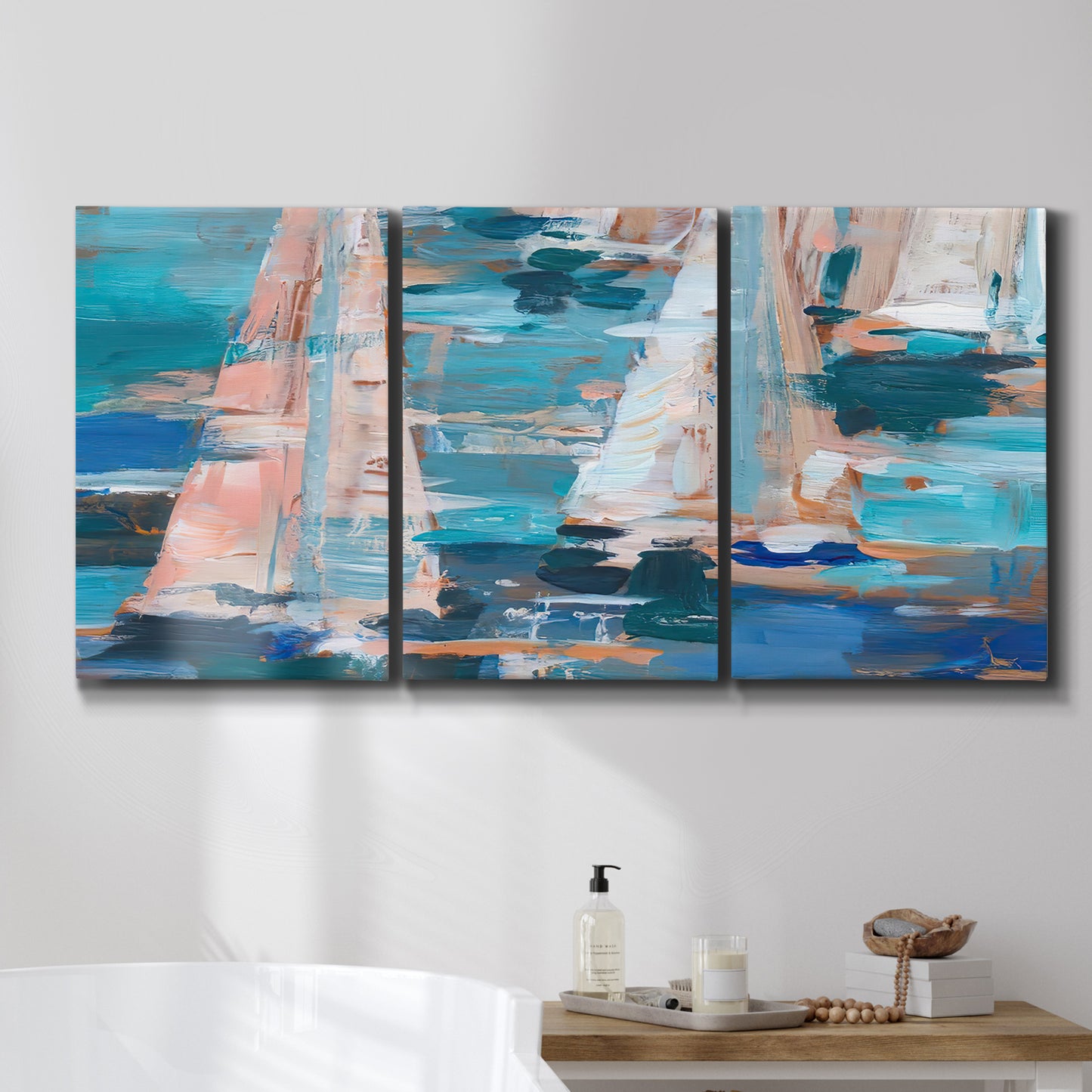 Three-panel canvas wall art featuring graphic pop style sailboats, displayed in a bathroom above a bathtub.