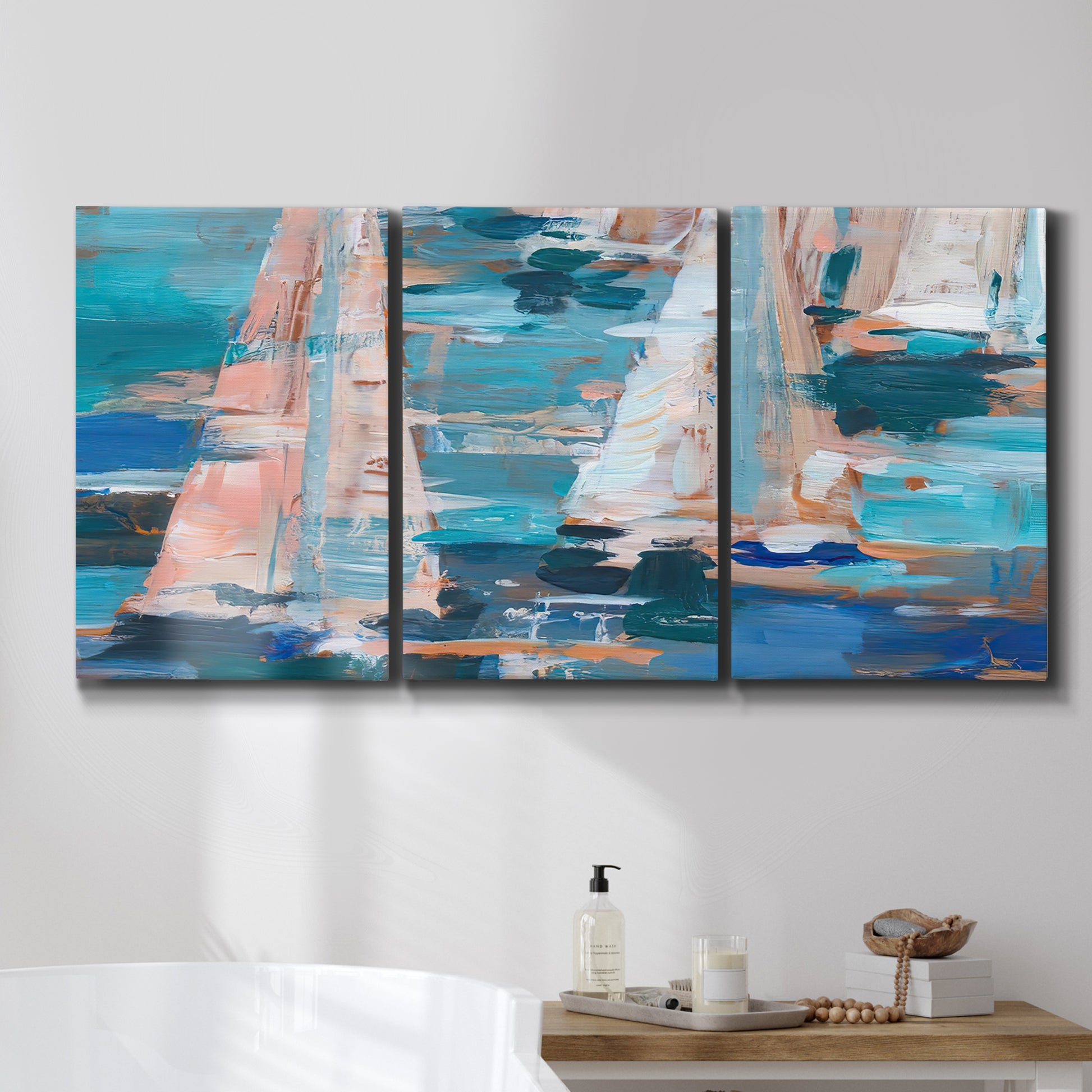 Three-panel canvas wall art featuring graphic pop style sailboats, displayed in a bathroom above a bathtub.