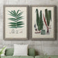 Set of two gray barnwood framed canvas prints depicting a coordinated art pair of vintage fern specimens with botanical details rendered as natural-history fern plates above a sofa in a modern living room.