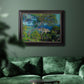 Impressionist Mediterranean coastal landscape by Claude Monet in an ornate black frame with gilded inner detail displayed in a dark-toned interior setting.