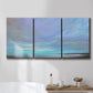 Three-panel canvas wall art featuring coastal shoreline with gentle surf, displayed in a bathroom above a bathtub.