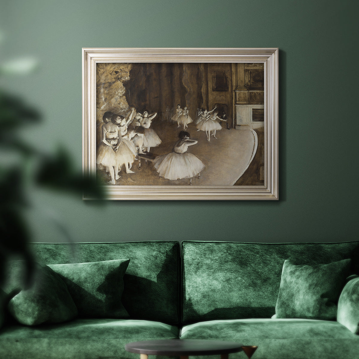 Impressionist ballet rehearsal scene by Edgar Degas in an ornate champagne frame displayed in a dark-toned interior setting.