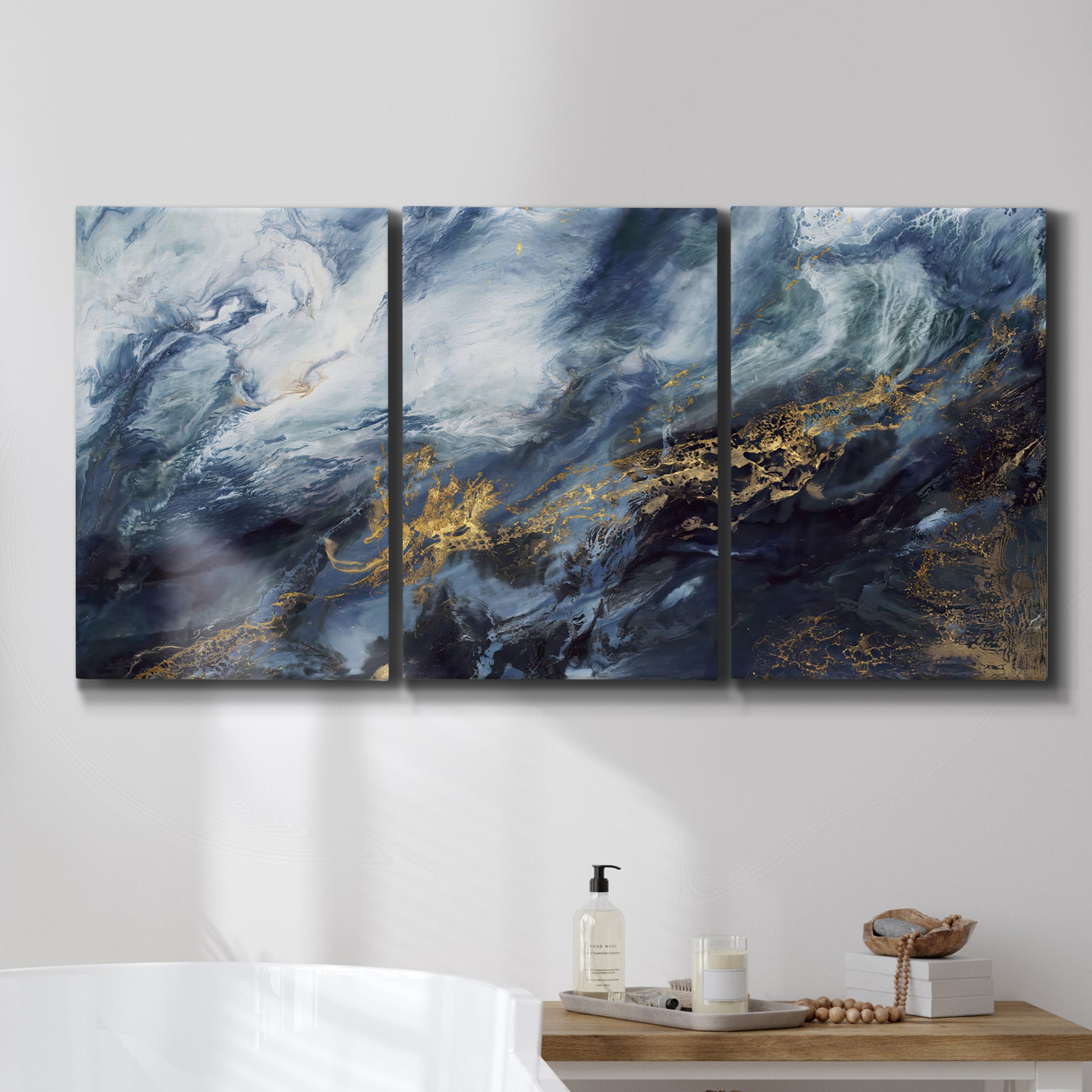 Three-panel canvas wall art featuring soft abstract landscape anticipation tones, displayed in a bathroom above a bathtub.