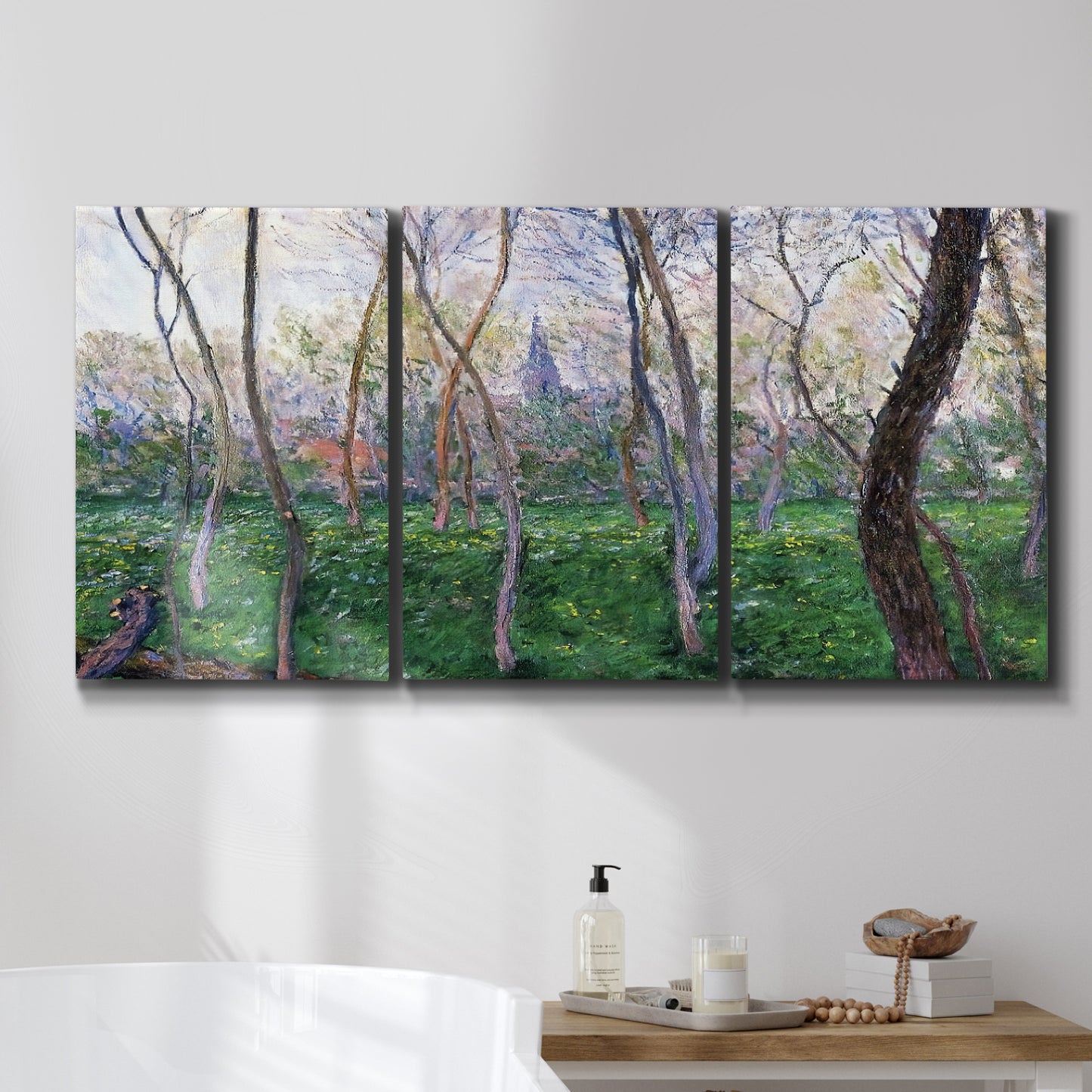 Three-panel canvas wall art featuring spring landscape along river, displayed in a bathroom above a bathtub.