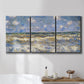 Three-panel canvas wall art featuring rough sea with crashing waves, displayed in a bathroom above a bathtub.