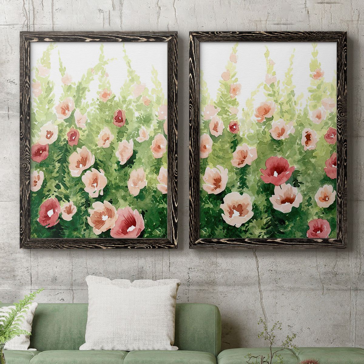Set of two black barnwood framed canvas prints depicting a coordinated art pair of a field of pink coral and white flowers rendered as luminous impressionistic floral paintings above a sofa in a modern living room.