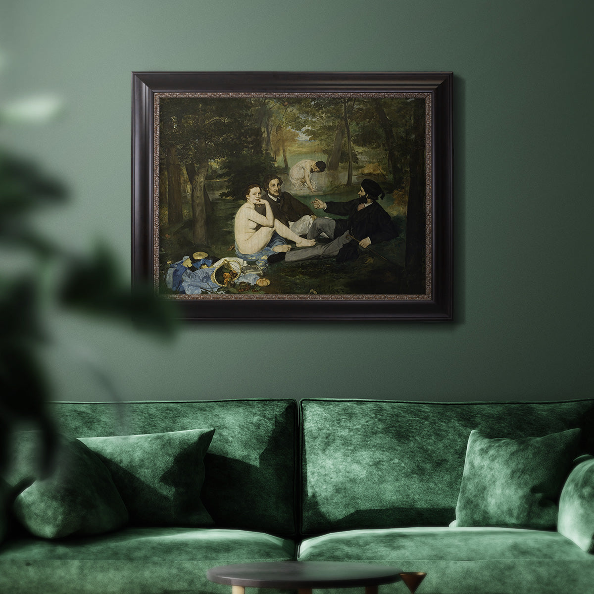 Groundbreaking impressionist picnic scene by Édouard Manet in an ornate black frame with gilded inner detail displayed in a dark-toned interior setting.