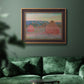 Impressionist haystack series landscape by Claude Monet in an ornate bronzed mahogany wood frame displayed in a dark-toned interior setting.