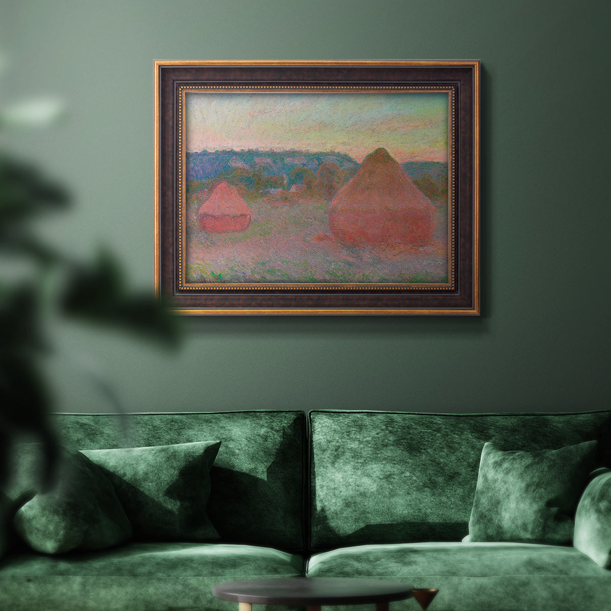Impressionist haystack series landscape by Claude Monet in an ornate bronzed mahogany wood frame displayed in a dark-toned interior setting.