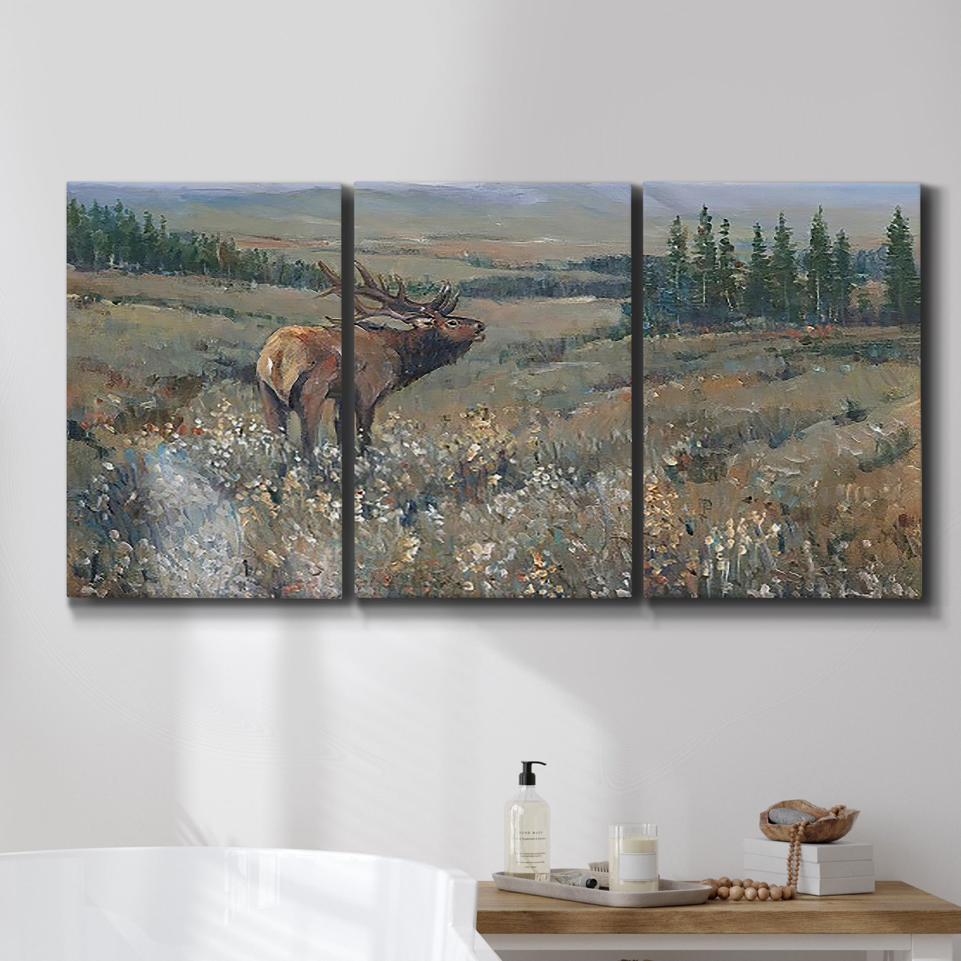 Three-panel canvas wall art featuring western wildlife grazing in open field, displayed in a bathroom above a bathtub.