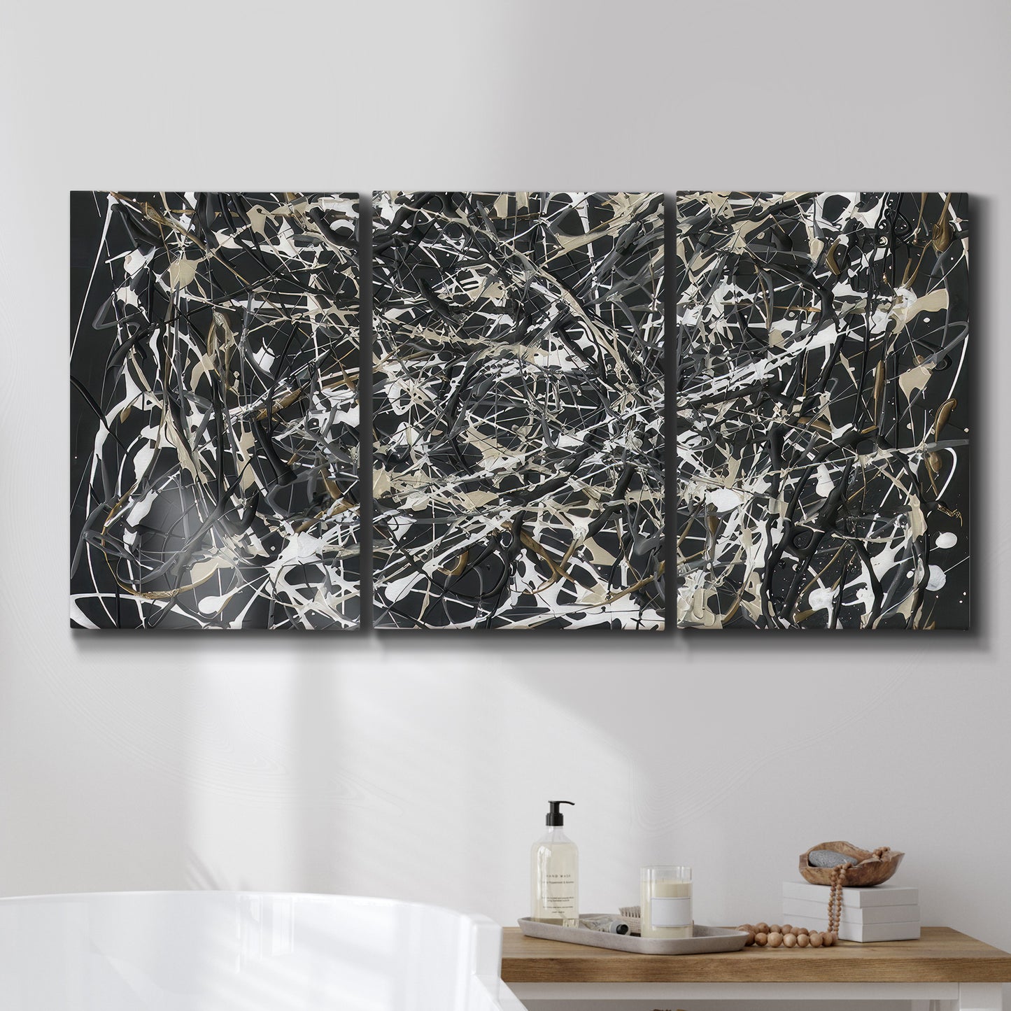 Three-panel canvas wall art featuring energetic expressionist abstract splatter, displayed in a bathroom above a bathtub.