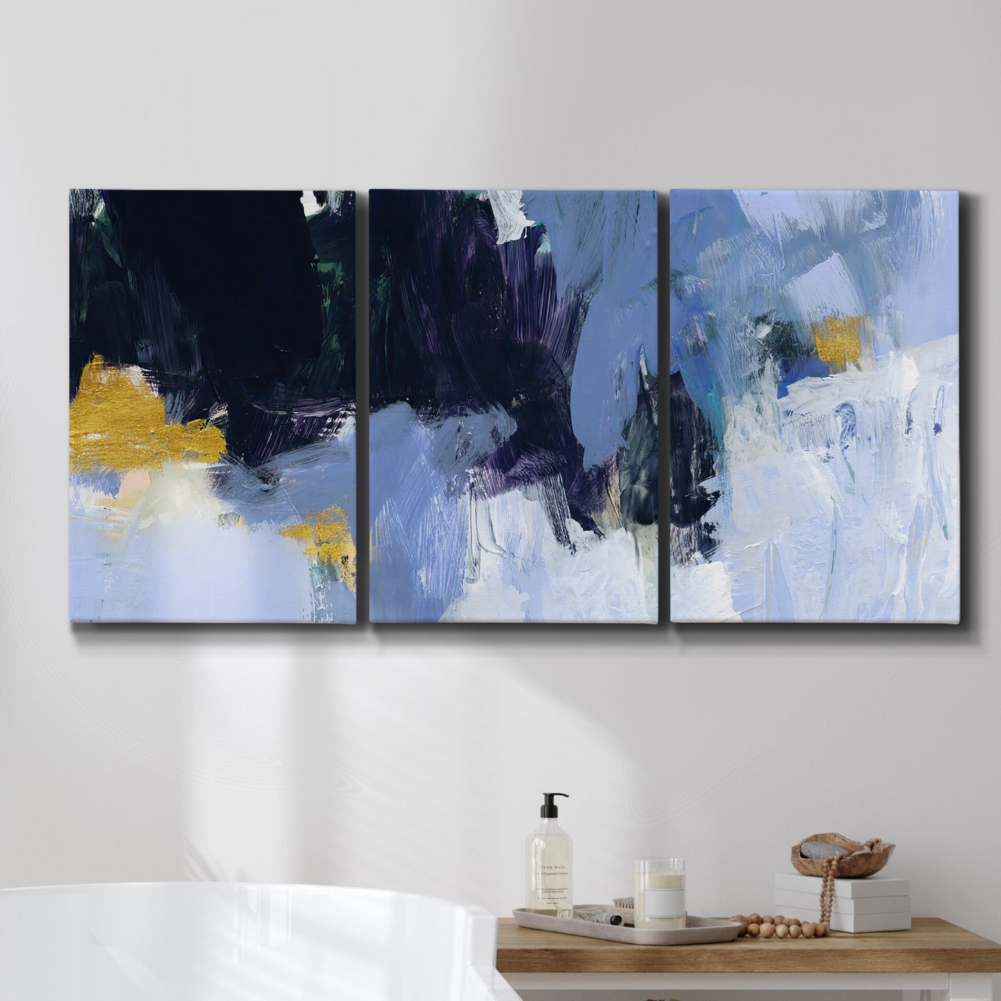 Three-panel canvas wall art featuring icy abstract arctic ledge, displayed in a bathroom above a bathtub.