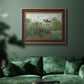 Impressionist garden landscape at Argenteuil by Claude Monet in an ornate bronzed mahogany wood frame displayed in a dark-toned interior setting.