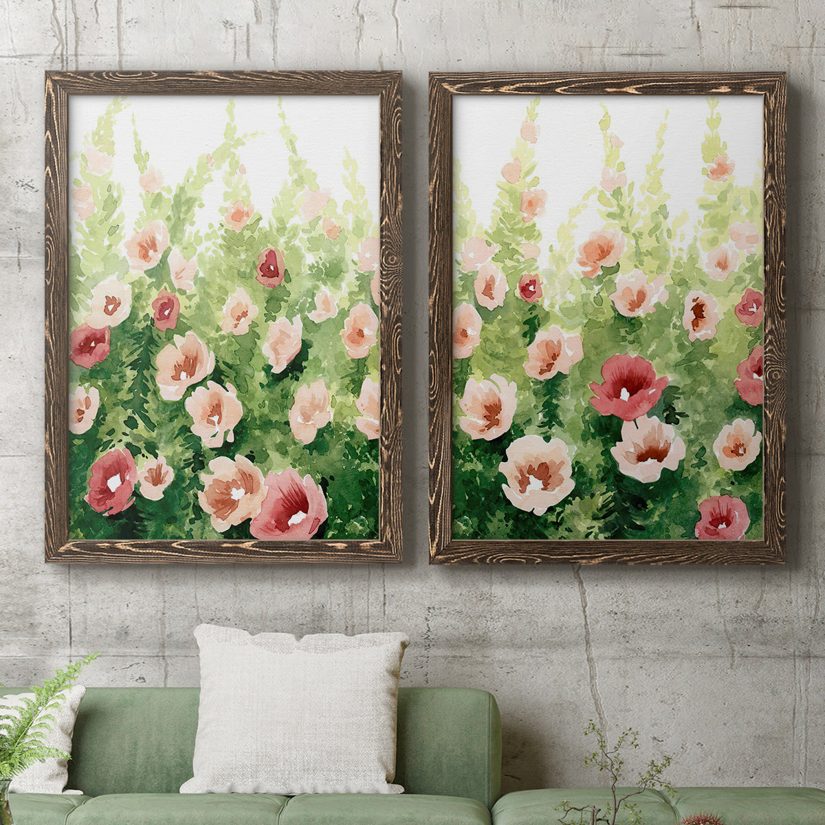 Set of two walnut barnwood framed canvas prints depicting a coordinated art pair of a field of pink coral and white flowers rendered as luminous impressionistic floral paintings above a sofa in a modern living room.