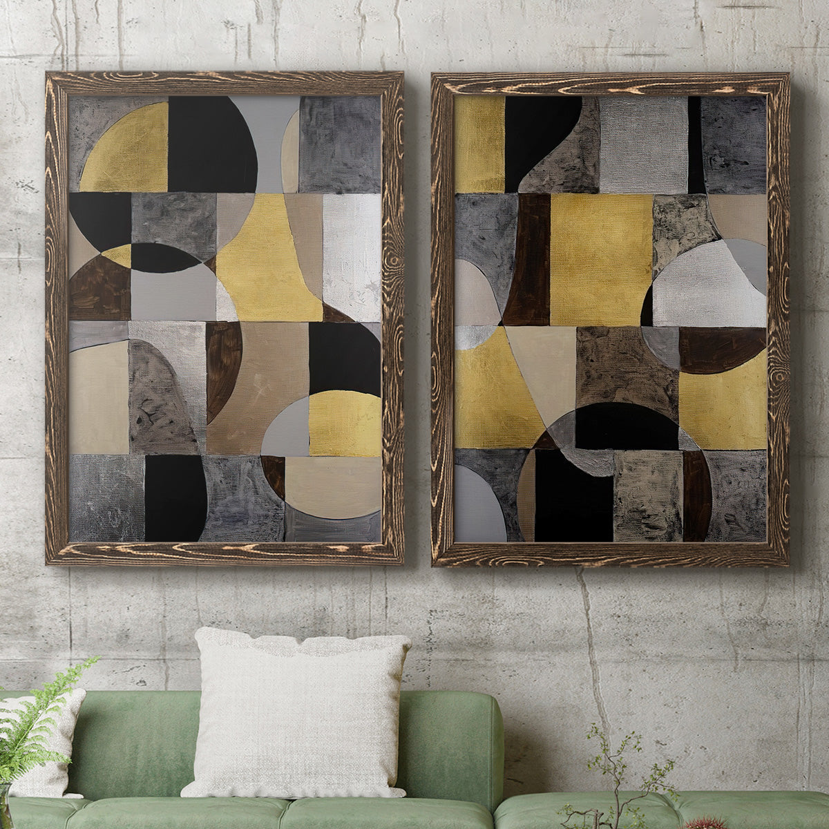 Set of two walnut barnwood framed canvas prints depicting a coordinated art pair of interlocking black gray cream and gold geometric sections rendered as structured modern abstracts above a sofa in a modern living room.