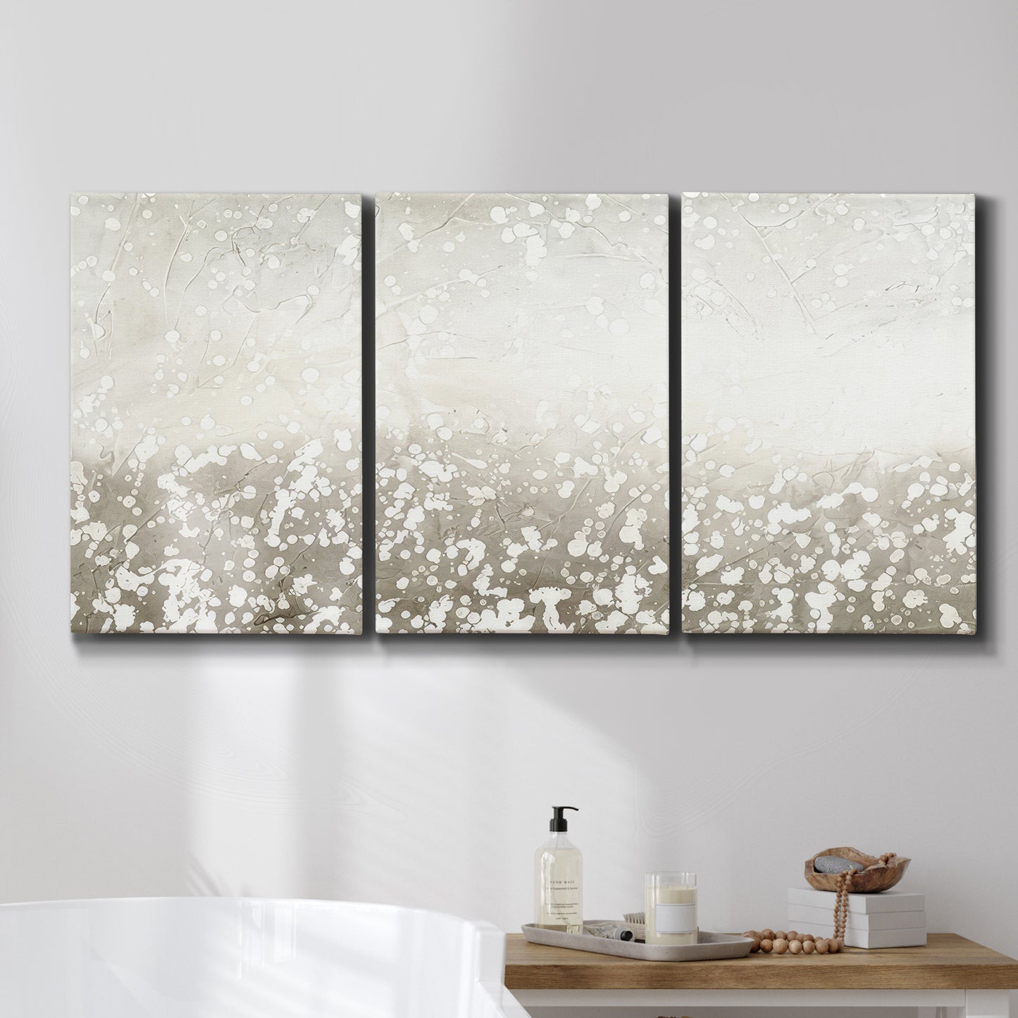 Three-panel canvas wall art featuring dark textured abstract mist, displayed in a bathroom above a bathtub.