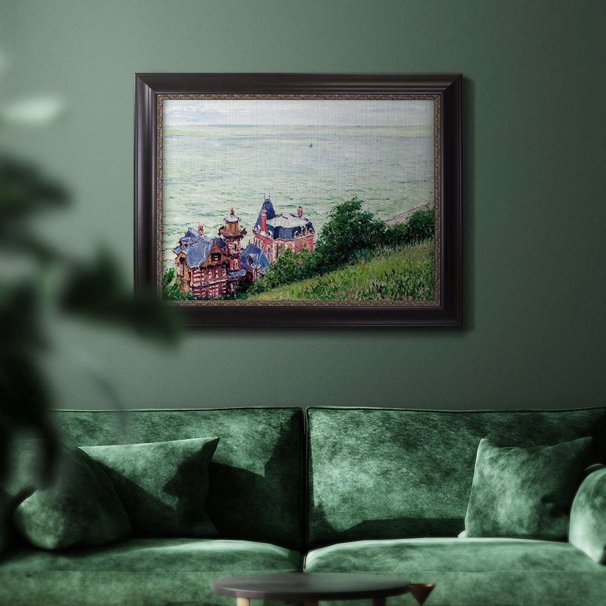 Impressionist coastal villas landscape by Gustave Caillebotte in an ornate black frame with gilded inner detail displayed in a dark-toned interior setting.