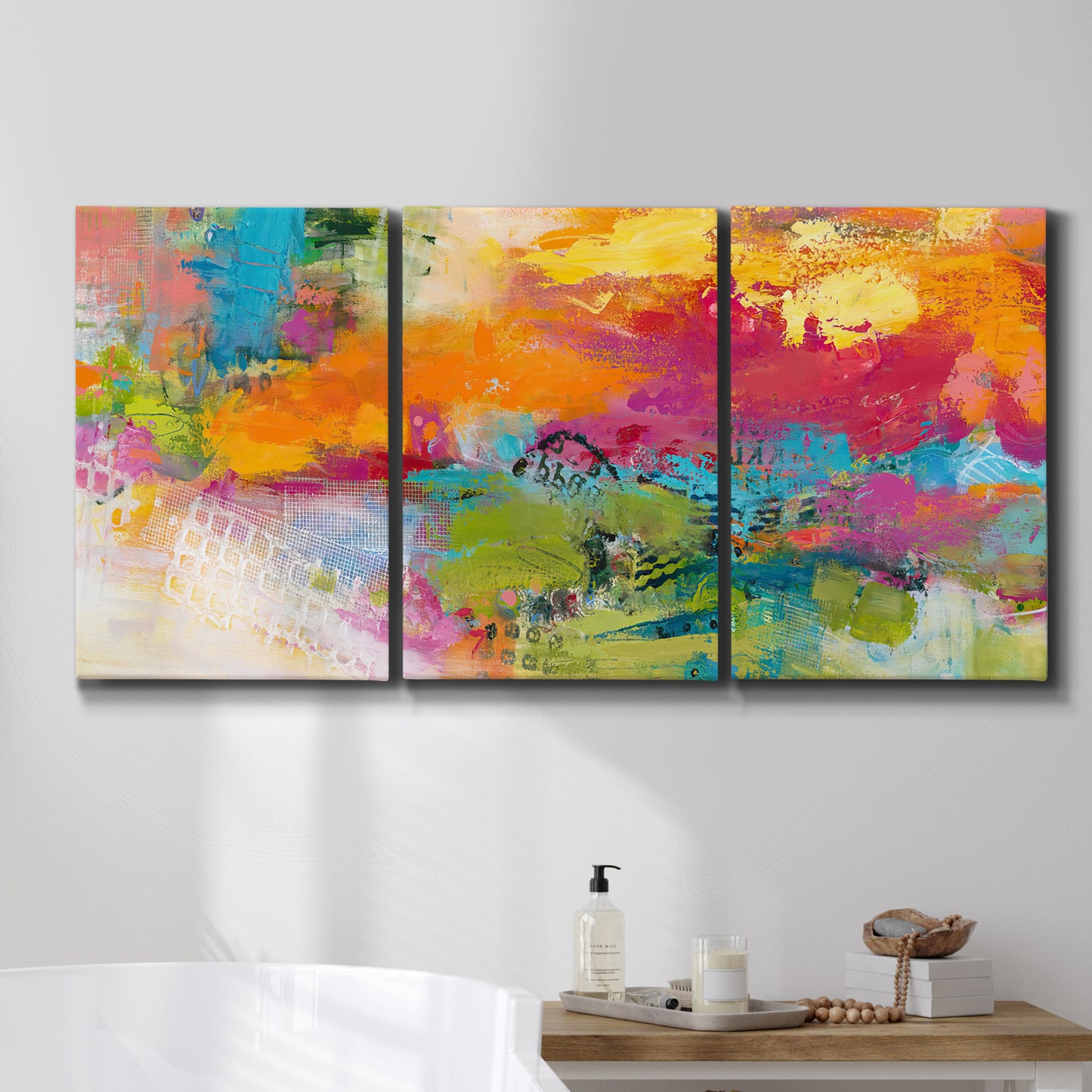 Three-panel canvas wall art featuring expressive abstract sunset tones, displayed in a bathroom above a bathtub.