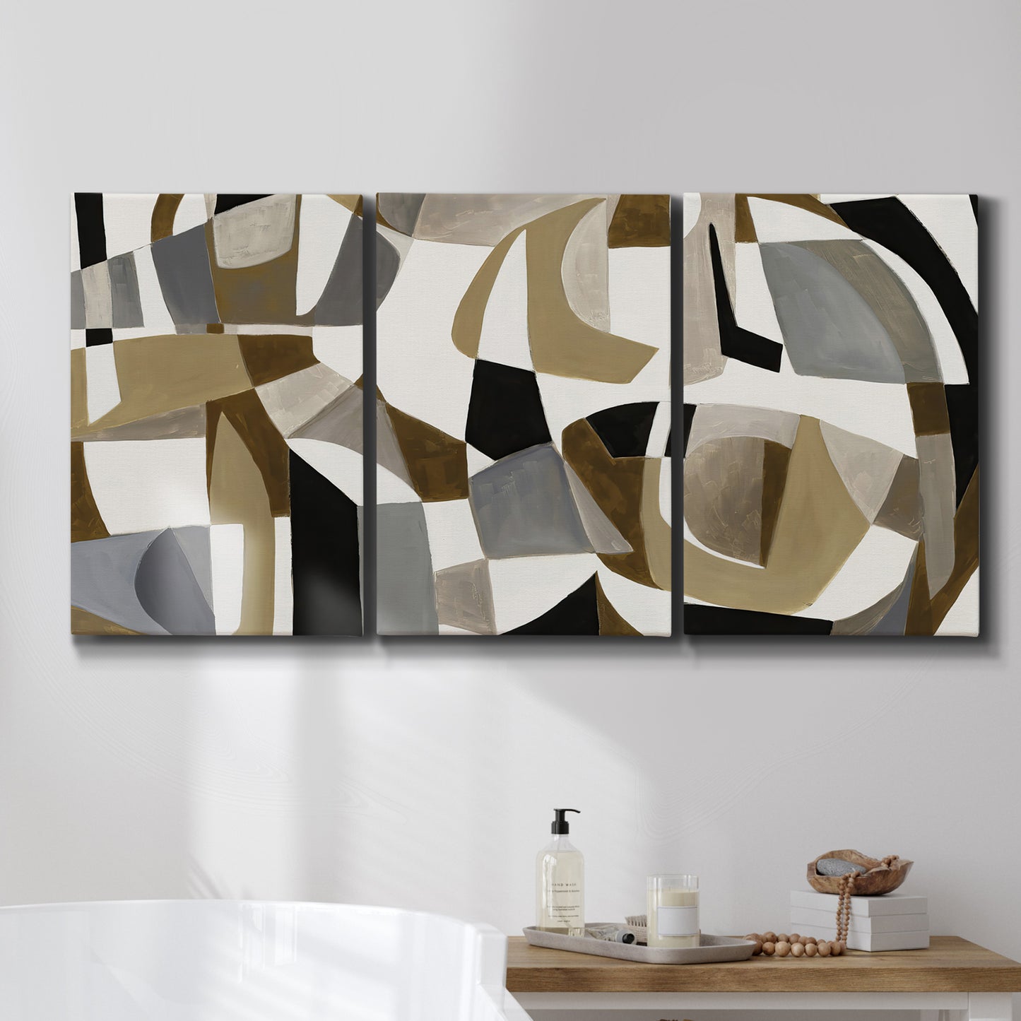 Three-panel canvas wall art featuring overlapping mid century geometric shapes, displayed in a bathroom above a bathtub.
