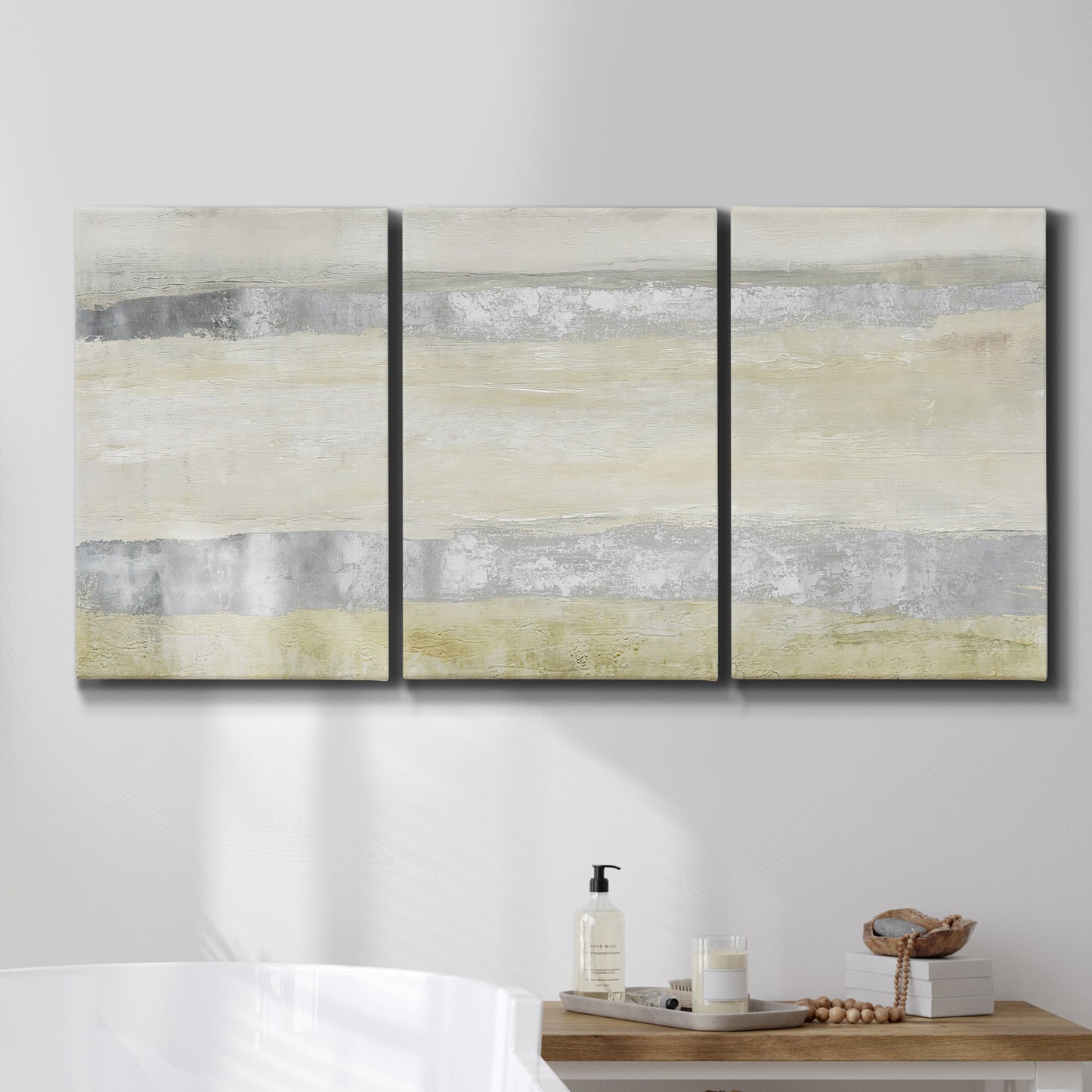 Three-panel canvas wall art featuring minimal abstract storm movement, displayed in a bathroom above a bathtub.