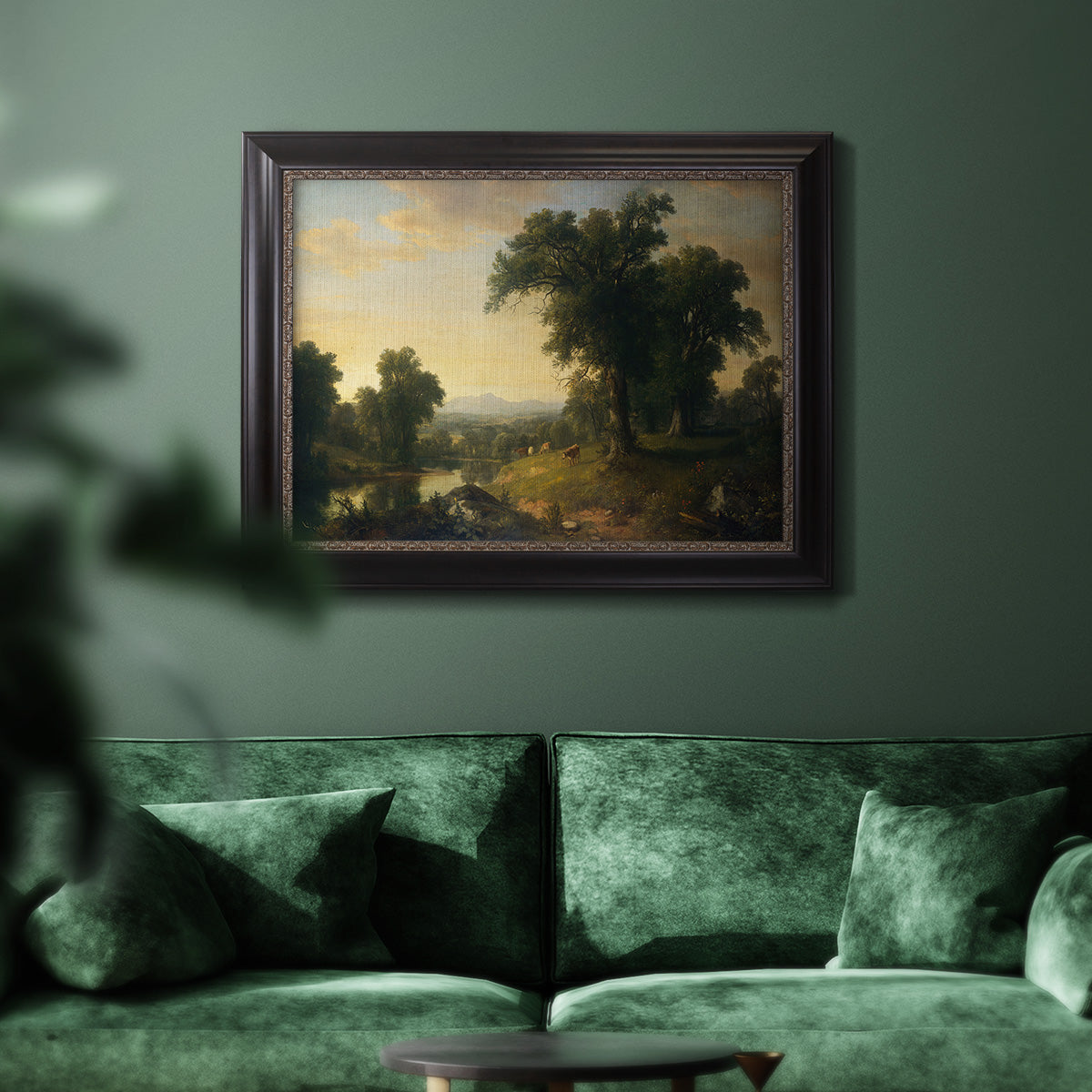 Traditional pastoral landscape painting by Asher Brown Durand in an ornate black frame with gilded inner detail displayed in a dark-toned interior setting.