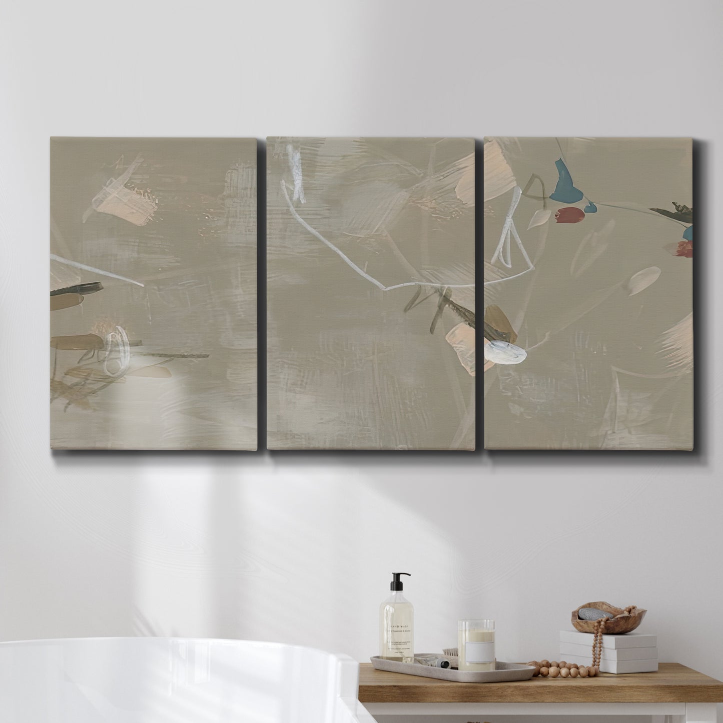 Three-panel canvas wall art featuring mid century terrazzo inspired abstraction, displayed in a bathroom above a bathtub.