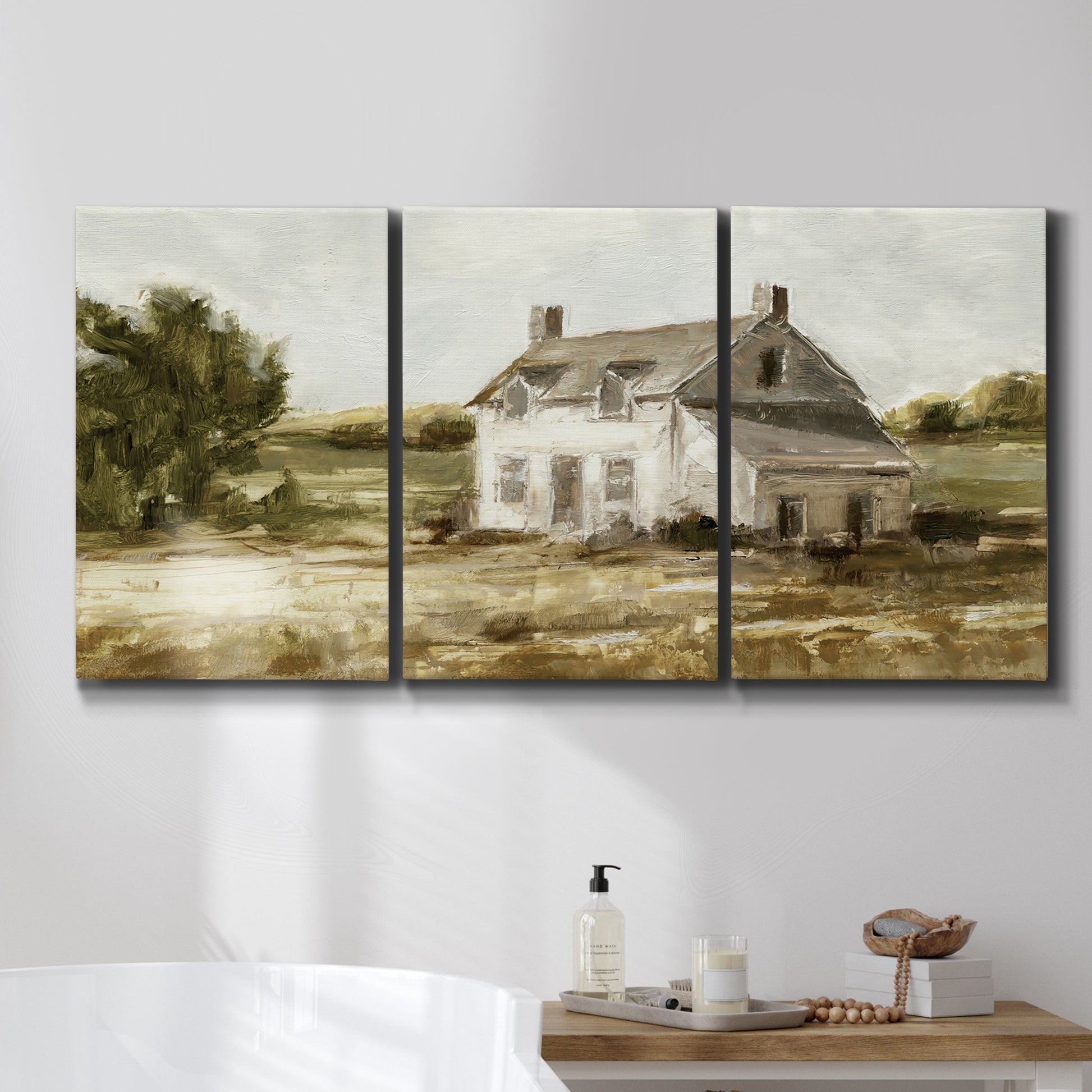 Three-panel canvas wall art featuring rural farmhouse harvest landscape, displayed in a bathroom above a bathtub.
