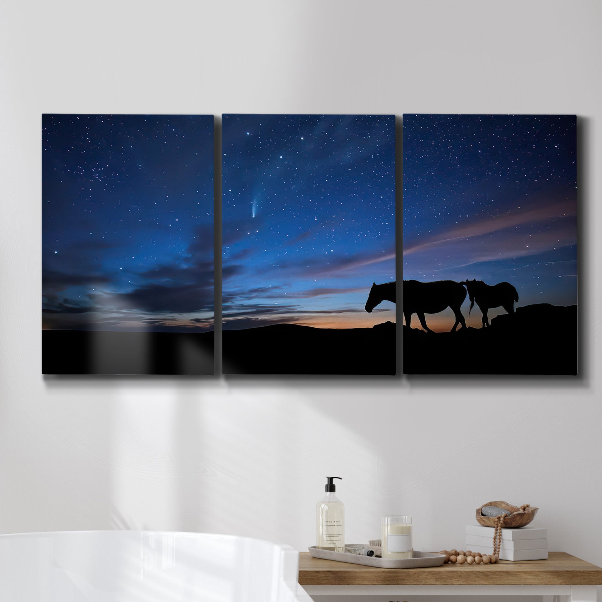 Three-panel canvas wall art featuring resting animals in open field, displayed in a bathroom above a bathtub.