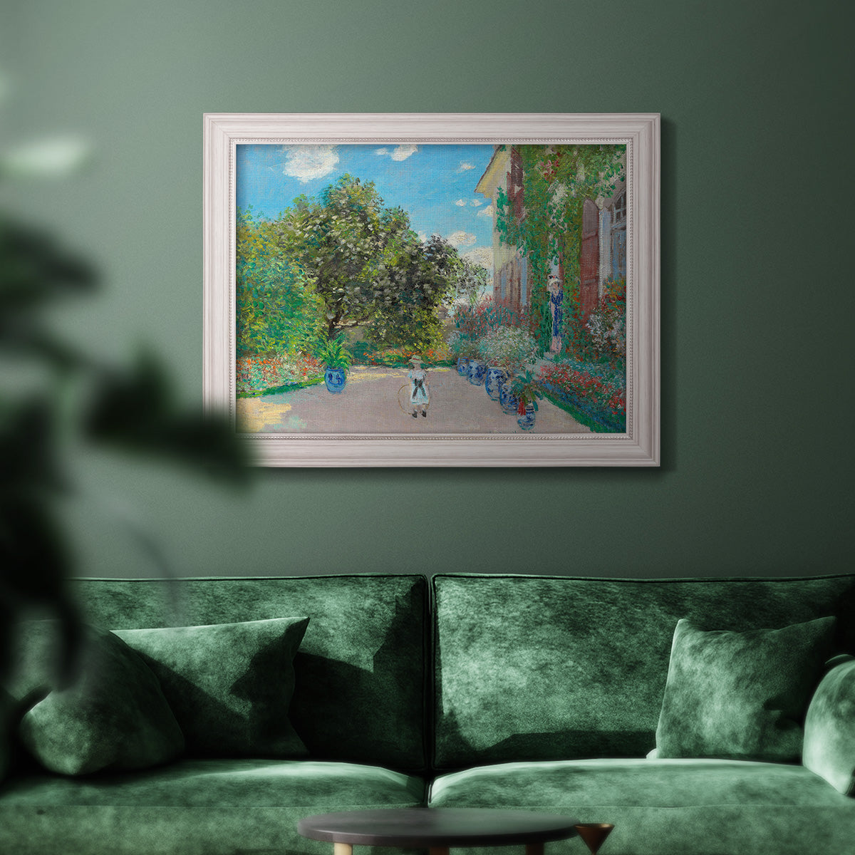 Impressionist residential landscape at Argenteuil by Claude Monet in an ornate weathered white frame displayed in a dark-toned interior setting.