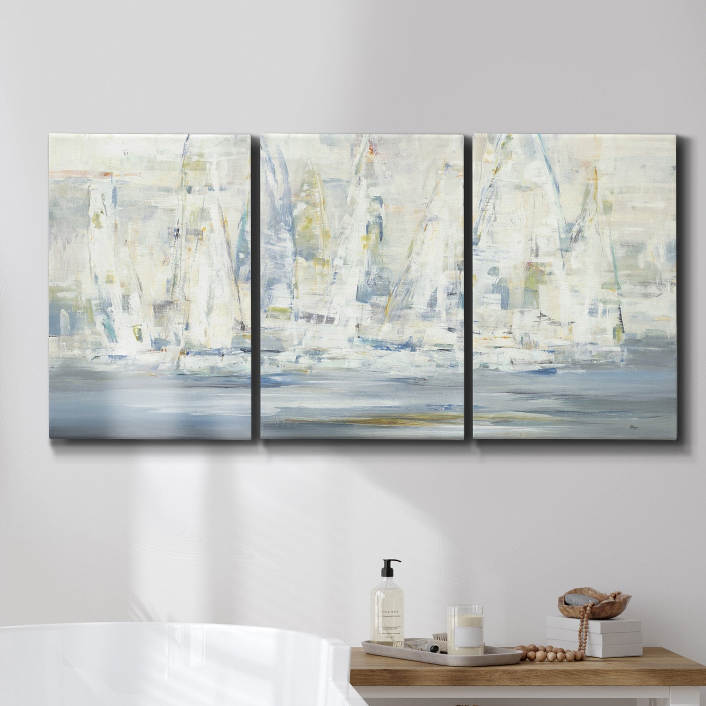 Three-panel canvas wall art featuring impressionist regatta scene with sailboats, displayed in a bathroom above a bathtub.