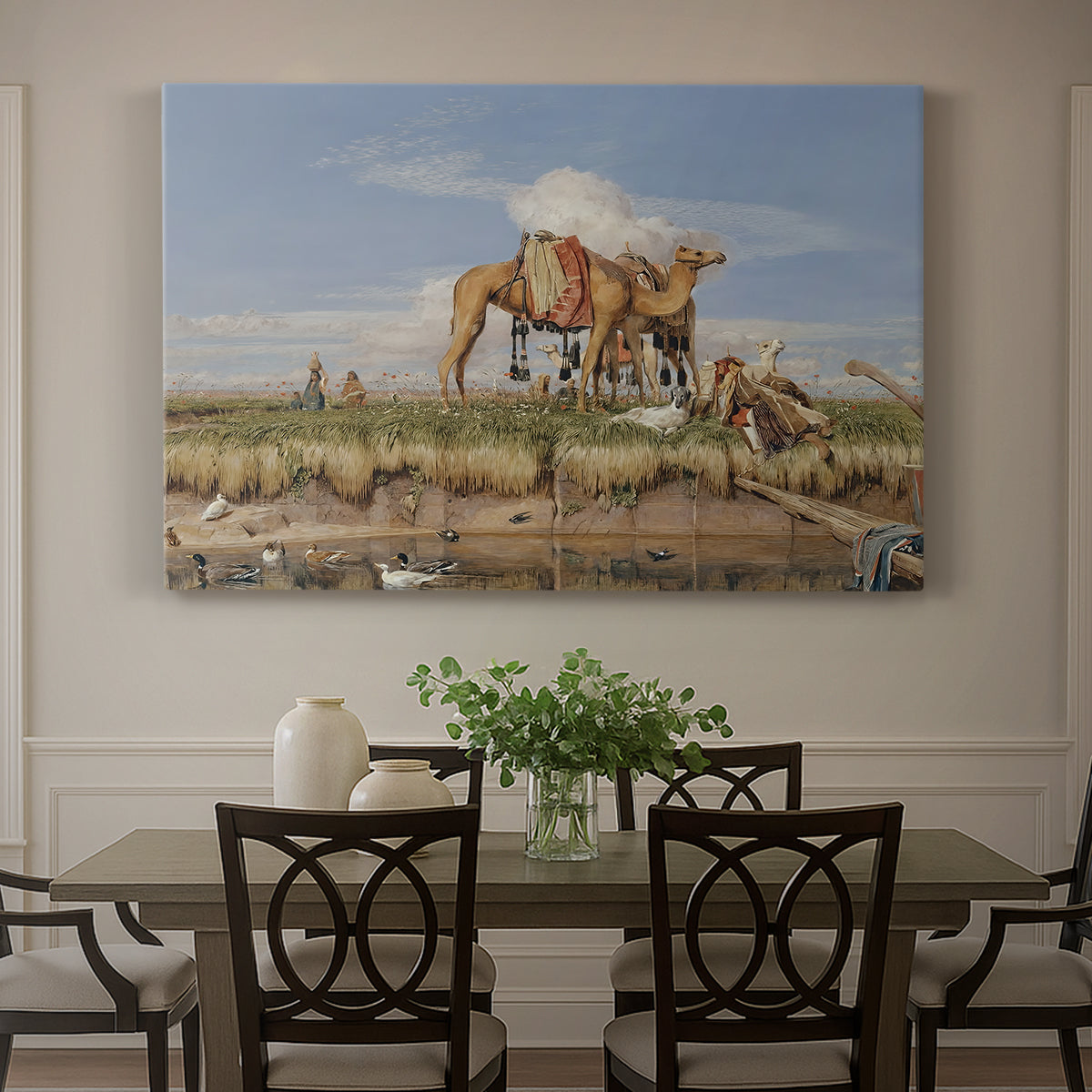 Canvas art print featuring figures and animals along riverbank with desert landscape, showcased as a statement wall artwork