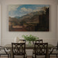 Canvas art print featuring a mountain landscape with town and river under dramatic sky, showcased as a statement wall artwork