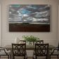 Canvas art print featuring a wide landscape beneath heavy grey clouds, showcased as a statement wall artwork