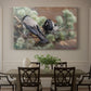 Canvas art print featuring two crows perched on ground among grass and earth tones, showcased as a statement wall artwork