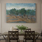 Canvas art print featuring twisting olive trees set within rolling landscape under vibrant sky, showcased as a statement wall artwork