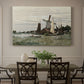 Canvas art print featuring a single windmill beside water with surrounding buildings and sky, showcased as a statement wall artwork