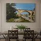 Canvas art print featuring an arched bridge spanning river with structure reflected in water, showcased as a statement wall artwork