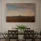Canvas art print featuring a low mountain landscape under warm sky with broad open foreground, showcased as a statement wall artwork