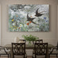 Canvas art print featuring a flock of birds in flight soaring across open sky above landscape, showcased as a statement wall artwork