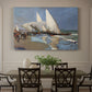 Canvas art print featuring boats and figures gathered along busy beach with sails and water, showcased as a statement wall artwork