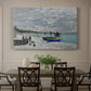 Canvas art print featuring a seaside promenade with figures, flags, and boats along the coast, showcased as a statement wall artwork