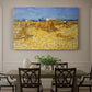 Canvas art print featuring stacked bundles of wheat arranged across harvested field under open sky, showcased as a statement wall artwork