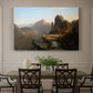 Canvas art print featuring a rugged mountain landscape with small figures near water and rocky cliffs, showcased as a statement wall artwork