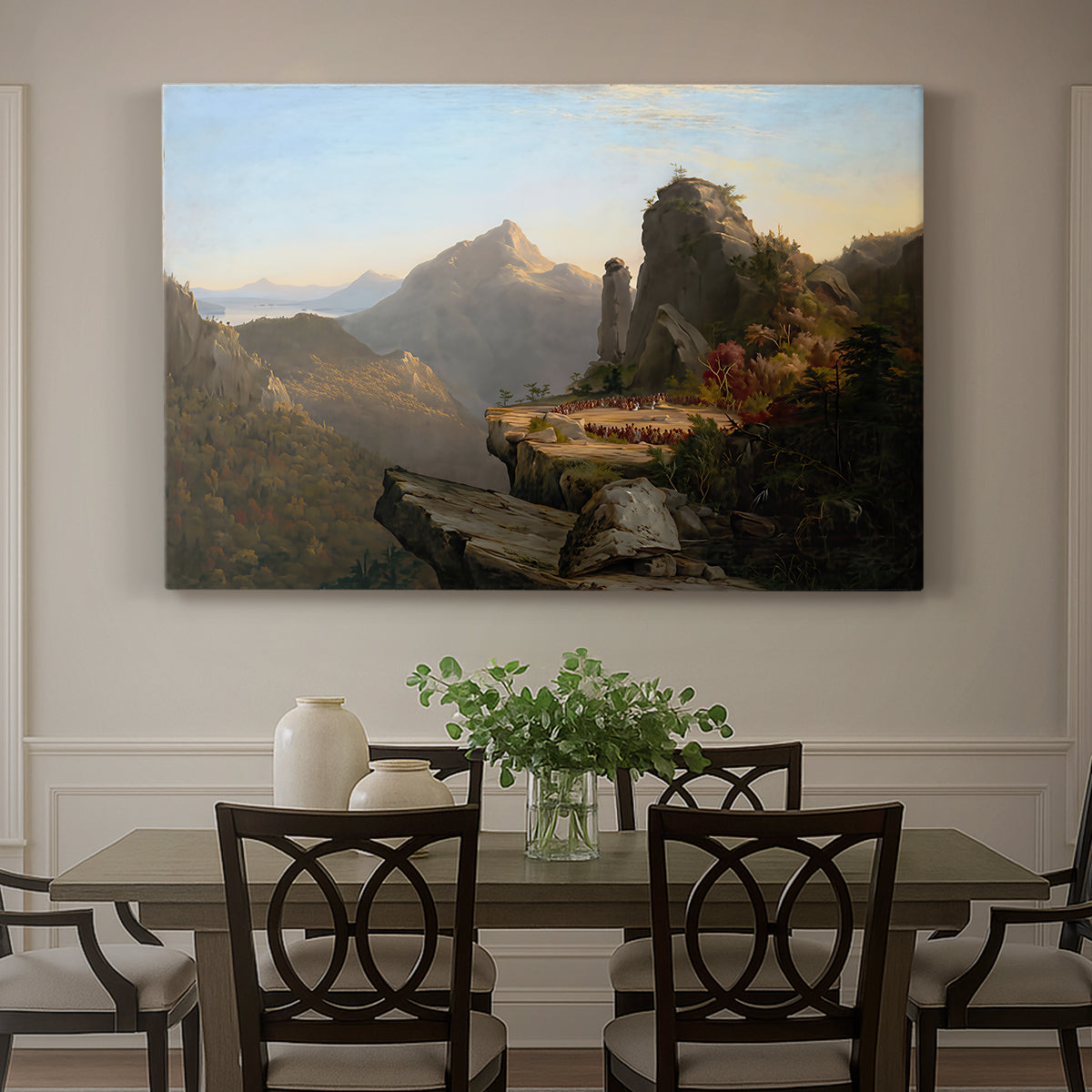 Canvas art print featuring a rugged mountain landscape with small figures near water and rocky cliffs, showcased as a statement wall artwork