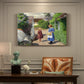 Canvas art print featuring people walking along village path beside houses in bright summer light, presented within a refined interior setting