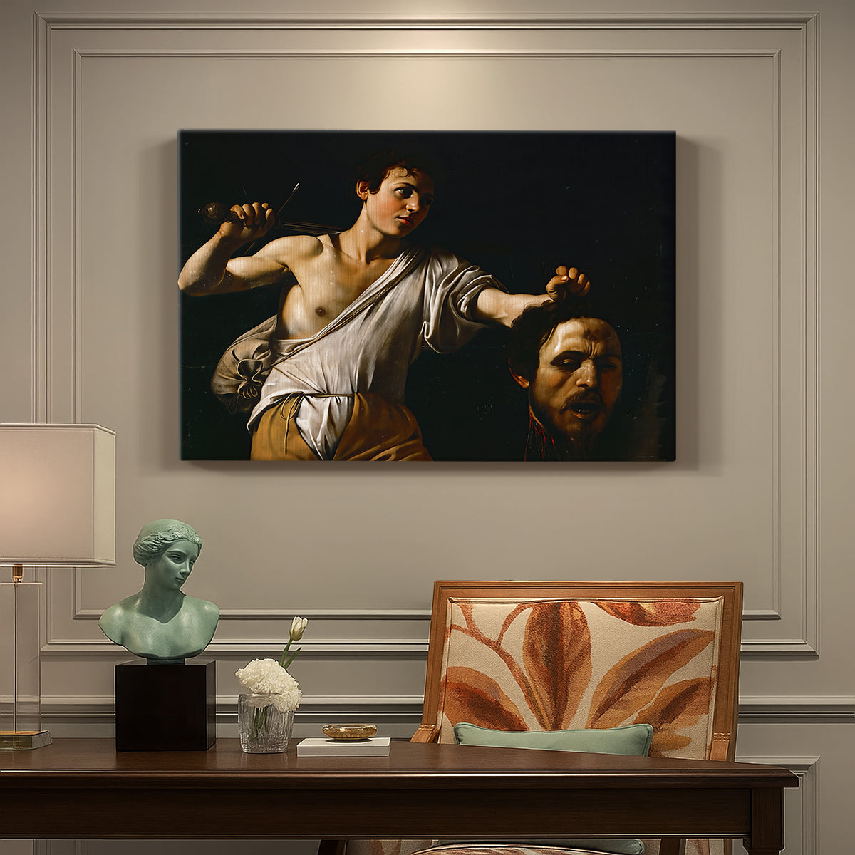 Canvas art print featuring a young David holding the severed head of Goliath against a dark background, presented within a refined interior setting