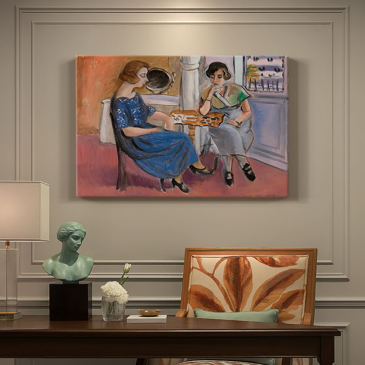 Canvas art print featuring two figures seated at a table playing dominoes in a colorful interior, presented within a refined interior setting